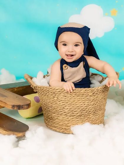 This little pilot is all smiles as he sits in his basket, ready to fly through the sky.