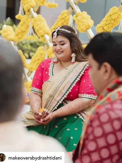 A serene moment during the ceremony. Her makeup is soft and natural, ensuring she looks like herself, just more radiant.