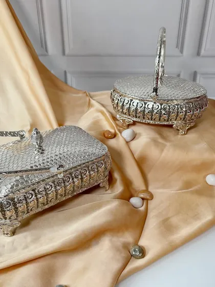 A collection of our versatile silver-plated baskets, showcasing different shapes. They are perfect for creating a cohesive gifting theme or for enhancing your space with timeless charm.