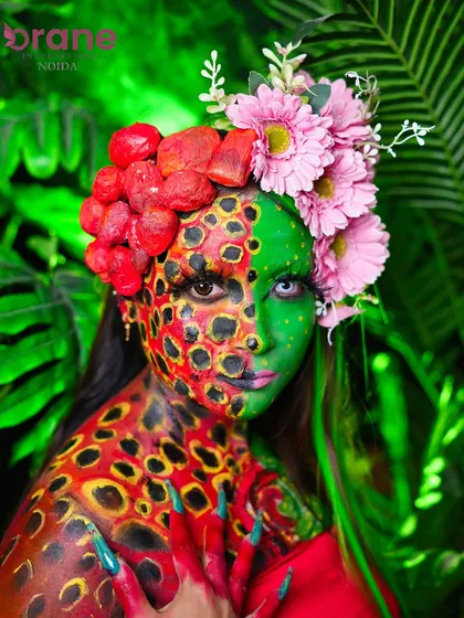 Our creative makeup courses push the boundaries of imagination. Here, a student has created a 'Nature's Fury' look, combining intricate body painting, custom prosthetics, and bold color theory.