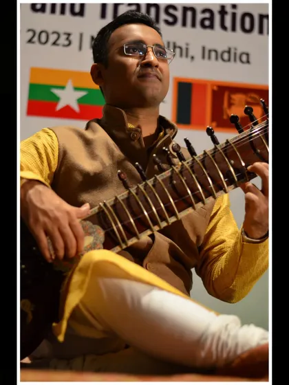 Performing in a formal jacket over a kurta, a versatile look for different events.
