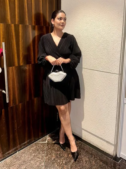 This pose shows the clutch from a slightly different angle, catching the light and showing off its fun, sculptural shape.