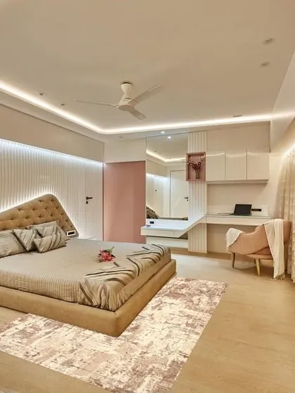 A bedroom designed with modern, dynamic lines. The asymmetrical headboard is accentuated with integrated lighting, and the room includes a sleek study nook, making it both stylish and functional.