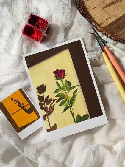 A moody, vintage-style polaroid painting of a single red rose and its shadow. I love the dramatic lighting in this piece.