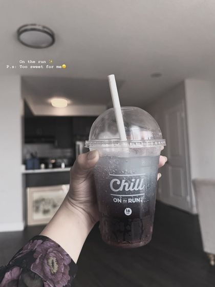 An "on the run" shot holding a drink, a very common and relatable type of lifestyle image.