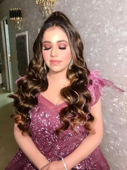 A beautiful shot of our client Anisha, dolled up for her engagement. We created a soft glam look with pink-toned eyeshadow and voluminous curls to match her stunning gown.