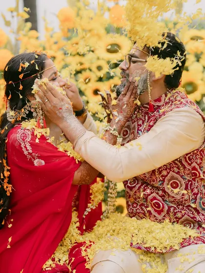 Playful and fun, the couple applies haldi to each other.