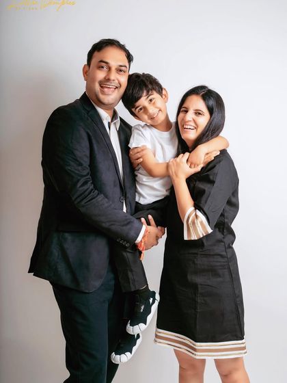 Laughter and love in this classic family portrait. Having the son on his father's back adds a fun, dynamic element to the shot.