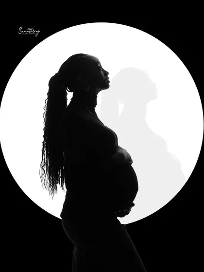 An artistic solo silhouette with a double exposure effect. This creative technique adds a layer of depth and mystery to the classic moon backdrop portrait.
