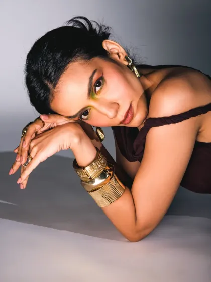 A softer, more contemplative moment from the "moonless sky" editorial. The pose is gentle, drawing attention to the hands, jewelry, and the thoughtful expression. This shows the emotional range we can capture within a single creative shoot.