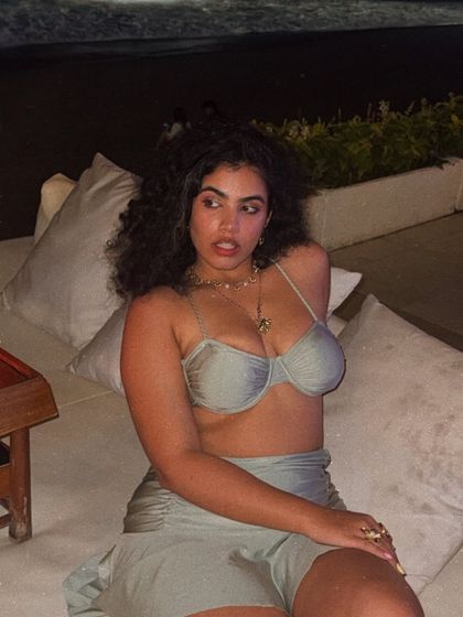 Another shot from the beach club, with the ocean in the background. The mood is relaxed yet chic, perfect for aspirational travel content.