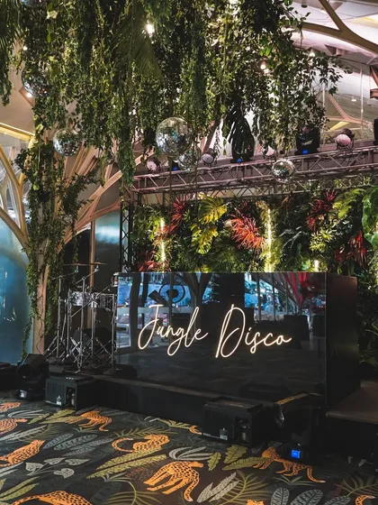 For a couple who wanted to dance the night away, we created a 'Jungle Disco' reception. This theme combined lush greenery with the vibrant energy of disco, featuring a custom neon sign, sparkling disco balls, and a dance floor that invited everyone to let loose.