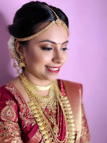 A side profile of this stunning South Indian bridal look. The makeup is designed to look flawless from every angle, with a focus on glowing skin and defined features.
