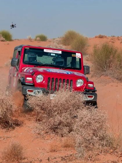 My FPV drone in the air, lining up a shot of a red Jeep Wrangler kicking up dust in the Bikaner desert.