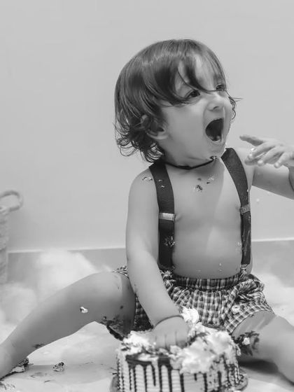 The pure joy of eating cake, amplified in this expressive black and white action shot.