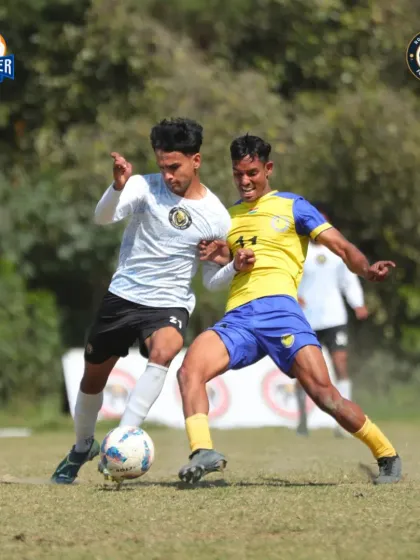 A tough tackle. This image shows the competitive nature of the league and our players' willingness to challenge for every ball.