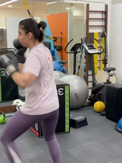 A patient practices boxing drills as part of her neck injury rehabilitation. This functional exercise helps improve coordination, strength, and confidence in movement after a period of being sidelined by pain.