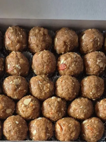 A box of Methi Laddoos made with jaggery, whole wheat flour, gond, and almonds.