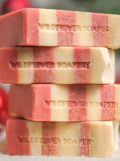 A close-up stack of striped Christmas soaps. Stacking products is a classic technique to create a sense of abundance and visual interest.