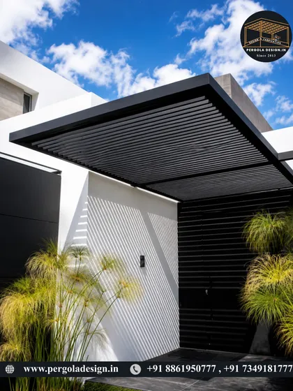 This attached carport demonstrates a minimalist aesthetic with its clean lines and louvered roof. The black steel structure provides a striking contrast to the white textured wall, creating a sophisticated and modern vehicle shelter that enhances the home's curb appeal.
