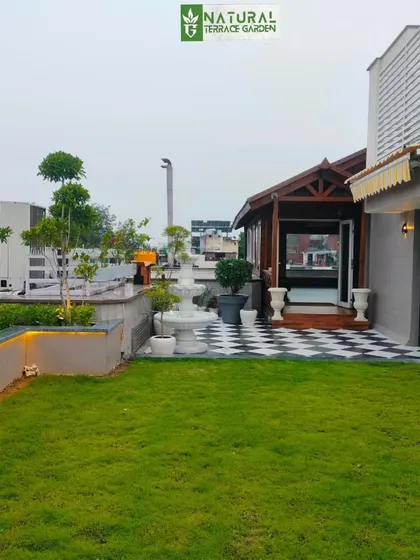 Another view of the New Friends Colony project, highlighting the checkered patio area and the seamless integration of green space and hardscaping.