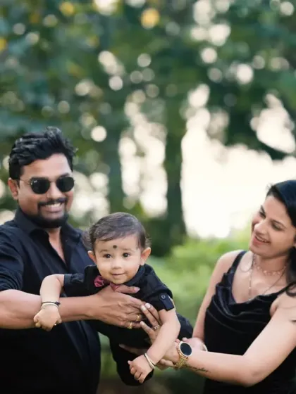 A happy family enjoying a moment together in the park. This candid shot captures the natural interaction and affection between parents and their child.