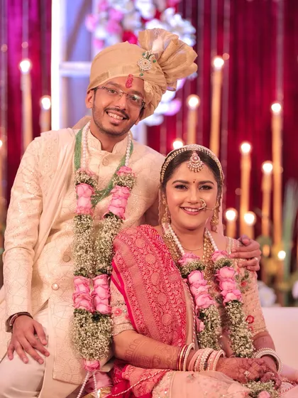 A close-up of the happy couple. The bride's soft, rosy makeup looks fresh and beautiful throughout the ceremony.
