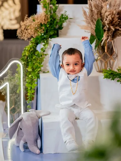 Look at this dapper little gentleman celebrating his big day. We love capturing the unique personality of every child, whether they are shy, energetic, or the star of the show. This portrait highlights the beautiful decor and the birthday boy's adorable outfit.