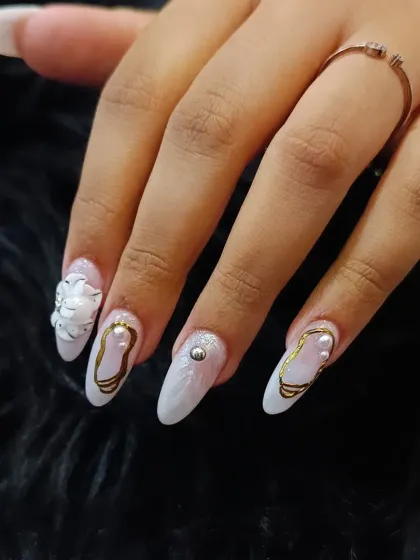 Experience the pinnacle of nail artistry with our signature 3D sculpted designs. This elegant almond-shaped set features delicate white 3D flowers, lustrous pearls, and fine gold detailing over a marbled base, creating a look of pure sophistication perfect for bridal events or any special occasion.