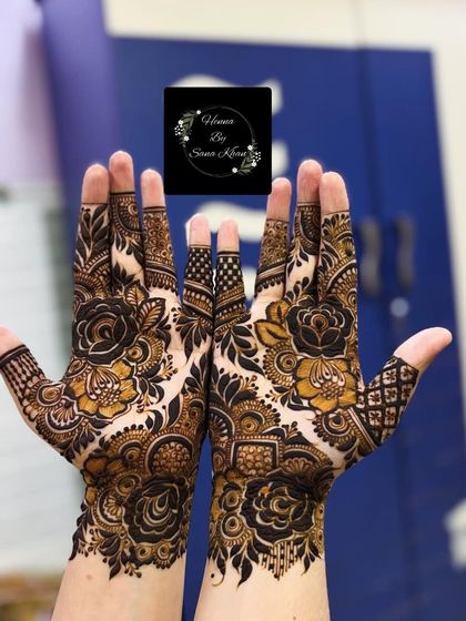 A beautiful floral design with a mix of different flower sizes and styles, creating a garden-like effect on the hands.