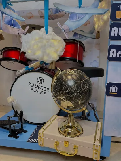 Inside the grand travel-themed structure, I included gifts that match the theme of world tours and adventure, like this mini drum kit and a vintage-style globe.