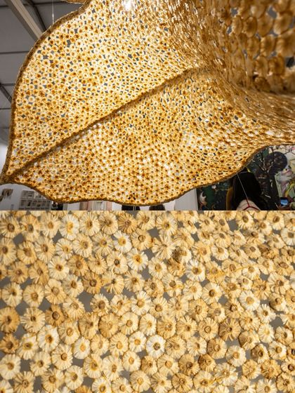 A composite image showing both the large, leaf-like sculpture and a detailed view of its surface. This juxtaposition highlights the contrast between the overall organic shape and the industrial origin of its components.