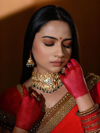 A conceptual bridal shot focusing on the tradition of 'alta' on the hands. The soft lighting and closed eyes create a serene and artistic mood, perfect for a creative portfolio.