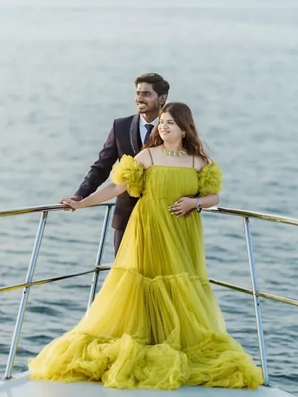 Create your own fairytale moment with a photoshoot on a yacht. This couple showcases our vibrant yellow tiered gown, a perfect choice for a pre-wedding shoot that is both romantic and unforgettable. I help you get these amazing shots with my collection of statement gowns.