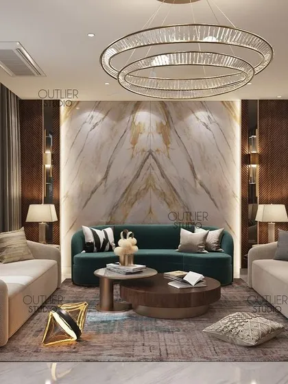 This living room showcases a beautiful book-matched marble feature wall, framed by dark wood paneling. The contrast of the dark green sofa and neutral chairs creates a balanced and luxurious seating area.