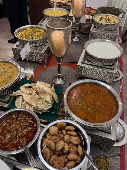 A close-up of the winter Indian spread, highlighting dishes like dal, chole, and papad, all designed to be warm and comforting.