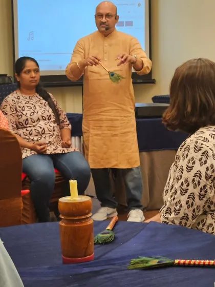 Demonstrating the use of a pendulum for dowsing and energy reading during the Sanjivani workshop. This is one of the many practical skills taught.