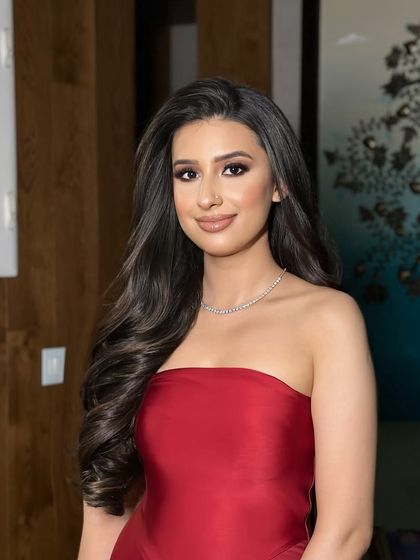 Styling open volume curls for a campaign. The hair is sleek at the top and cascades into perfect, uniform curls.