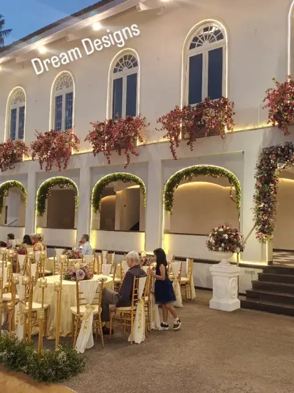 The venue's balconies are adorned with blooming bougainvillea, adding to the overall romantic and floral-rich design of this beautiful Parsi wedding.
