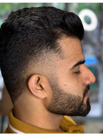 Another example of our flawless fade technique. The hair is blended perfectly from the skin up, creating a modern and stylish look.