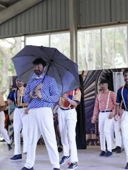 A playful moment from a performance inspired by classic cinema, complete with an umbrella prop.
