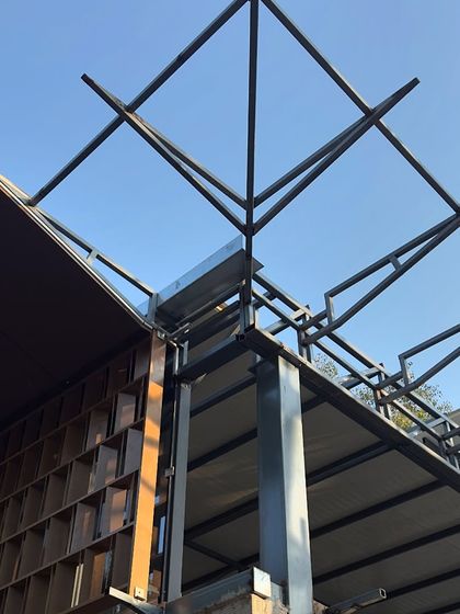 A detail of the steel framework for the roof and parametric facade of the Experience Center. This shows the intricate geometry that underpins the building's unique form.