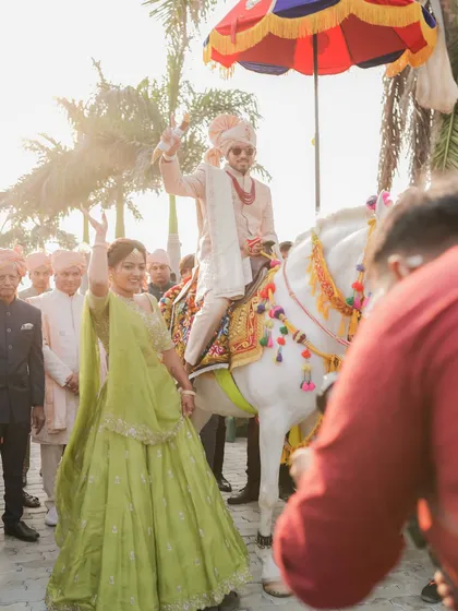 The sister of the groom leads the baraat with joy and energy. We styled her in a vibrant lime green lehenga that was perfect for a day wedding, allowing her to dance freely and celebrate.