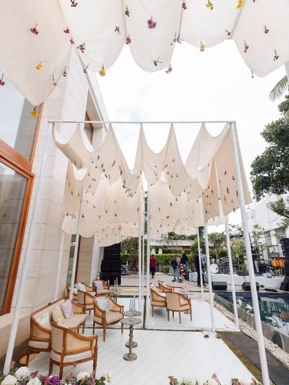 Another view of the hand-stitched floral canopies, creating a dreamy, floating ceiling for the intimate outdoor engagement.