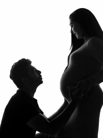 A silhouette showing the couple looking at each other. This pose adds a layer of intimacy and connection to the artistic silhouette style.