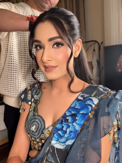 A close-up of the blue Haldi look. The eye makeup is a beautiful blend of blue and brown, and the skin is fresh and dewy.
