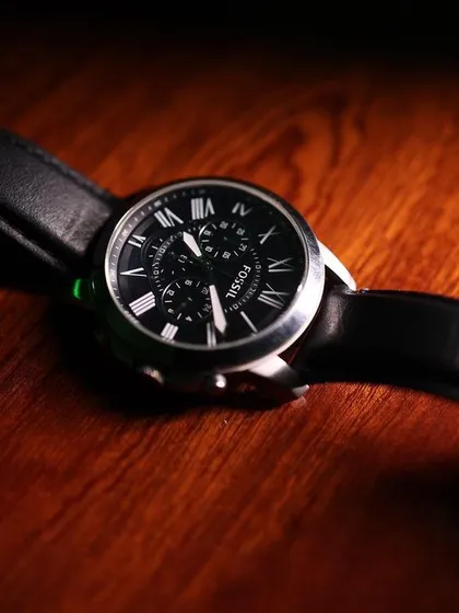 The groom's essentials matter too. A classic, moody shot of the groom's watch, highlighting the details that complete his look for the big day.