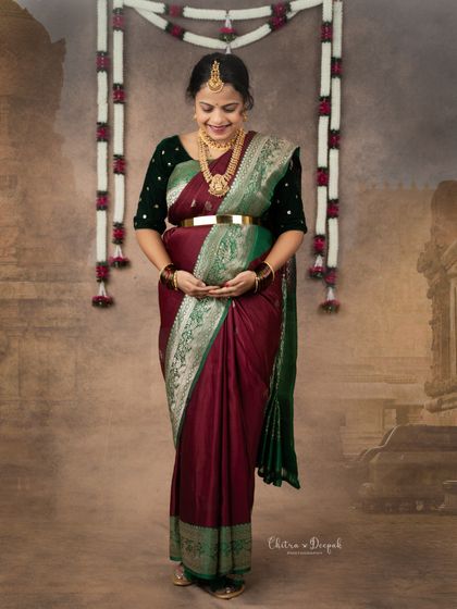 A deeply meaningful portrait. This mom-to-be is wearing her mother's wedding saree, creating a beautiful heirloom photo that connects generations.