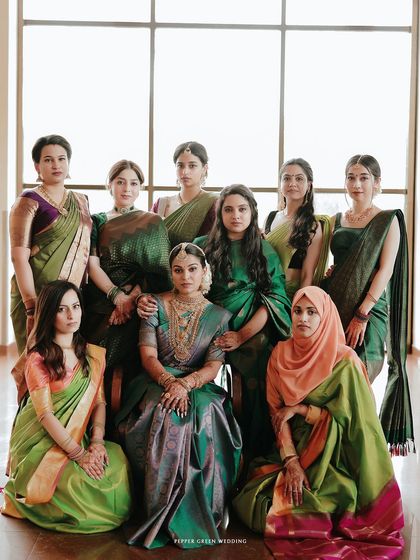 An elegant, formal portrait of the bride seated with her diverse group of friends, a beautiful picture of friendship.