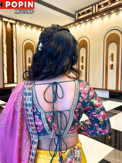 A view of the stunning back of the blouse for the yellow lehenga. The floral print and tie-up detail make it a showstopper.